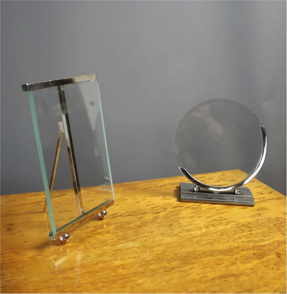 An art deco chrome photo frame of circular form on rectangular base