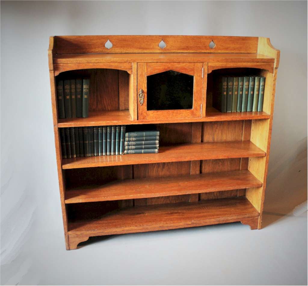 Arts and crafts oak bookcase with pierced spearhead cut-outs