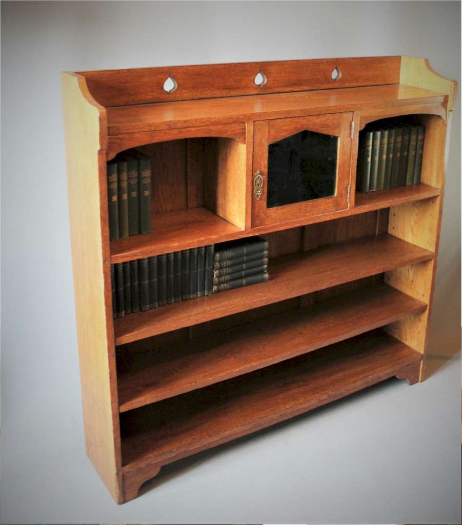 Arts and crafts oak bookcase with pierced spearhead cut-outs