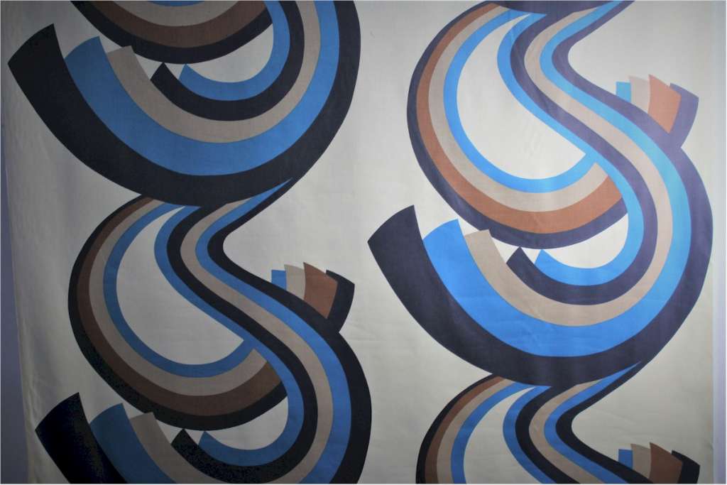 A Roll of 1970,s fabric swirling blue and brown geometric pattern