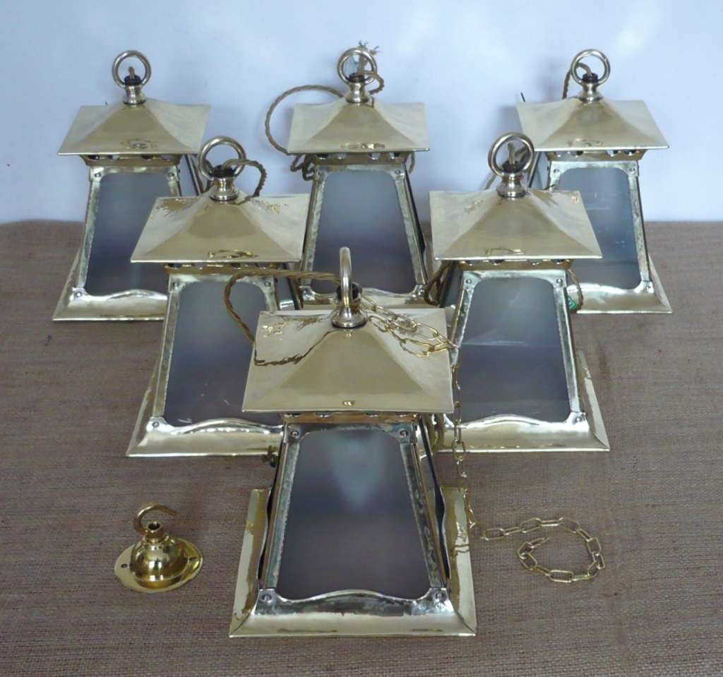 Good run of arts and crafts lanterns in brass
