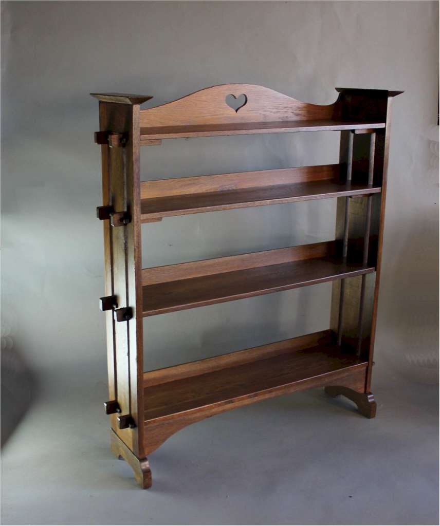 Arts & Crafts oak pegged bookcase with pierced heart to gallery