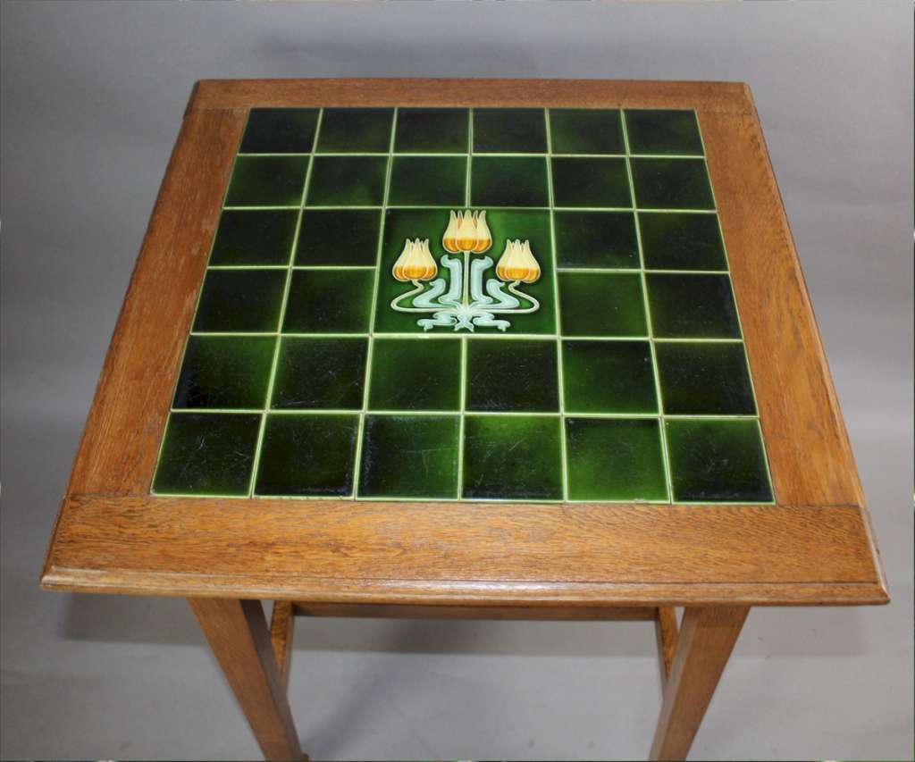 Arts and Crafts oak occasional table with tiled top.