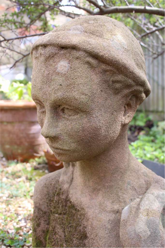 Garden statue in sandstone of  an Island girl