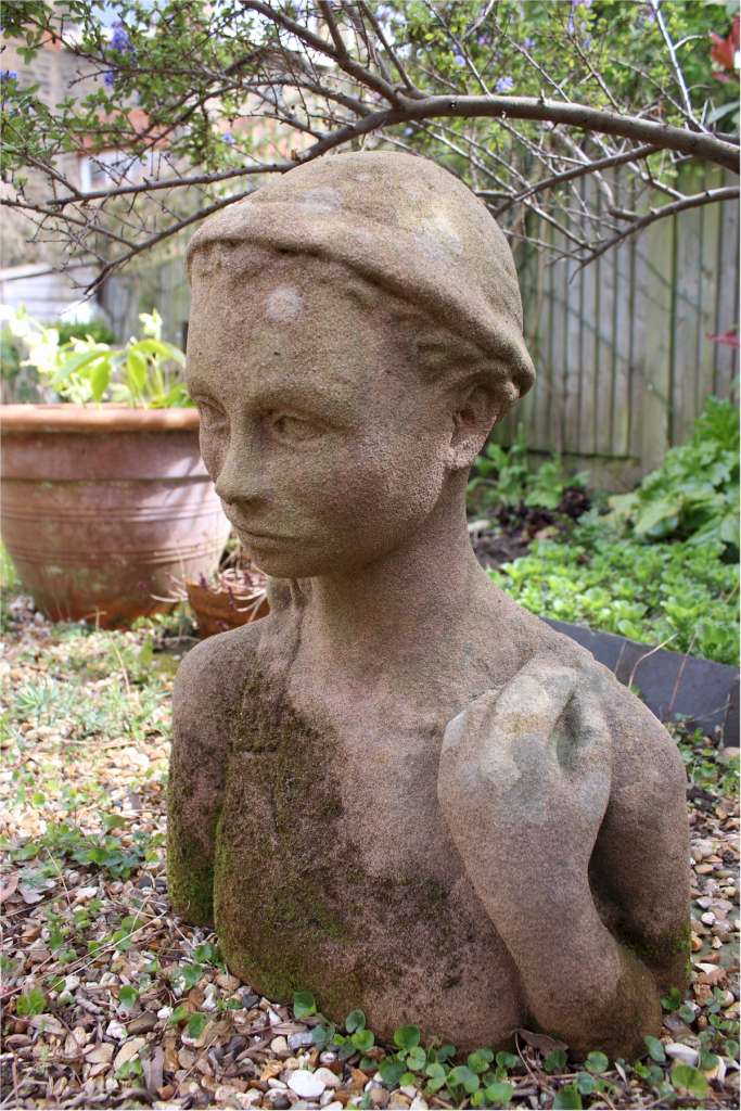 Garden statue in sandstone of  an Island girl