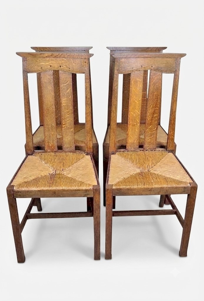 Arts and crafts oak dining chairs by Liberty