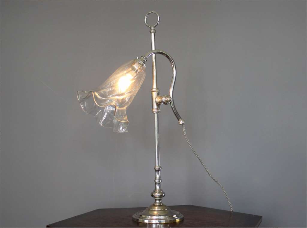 Elegant Edwardian adjustable table lamp with clear glass shade.