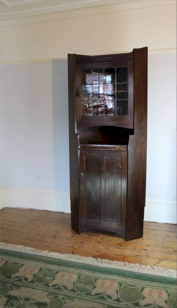 Arts and Crafts oak tall corner display cabinet by Liberty & Co circa 1900