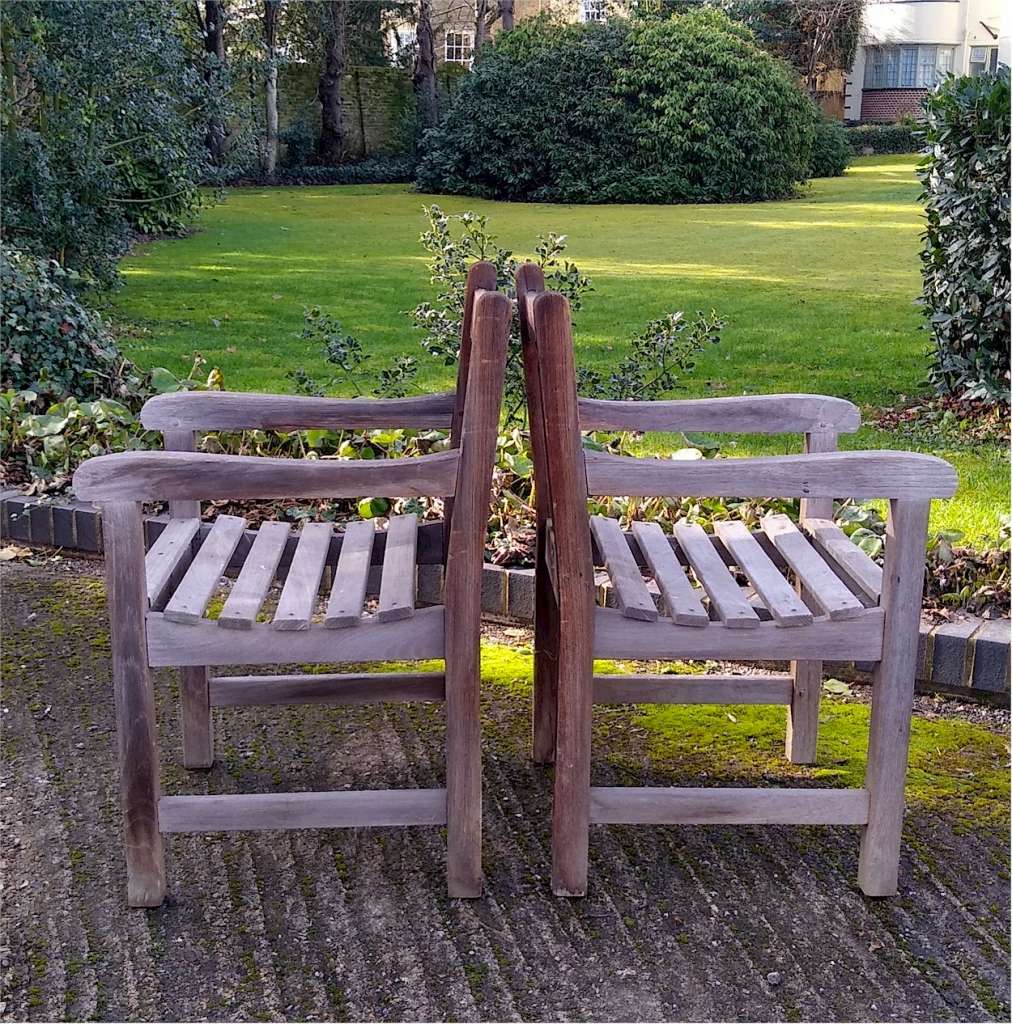 Pair of heavy , teak garden chairs , doweled joints