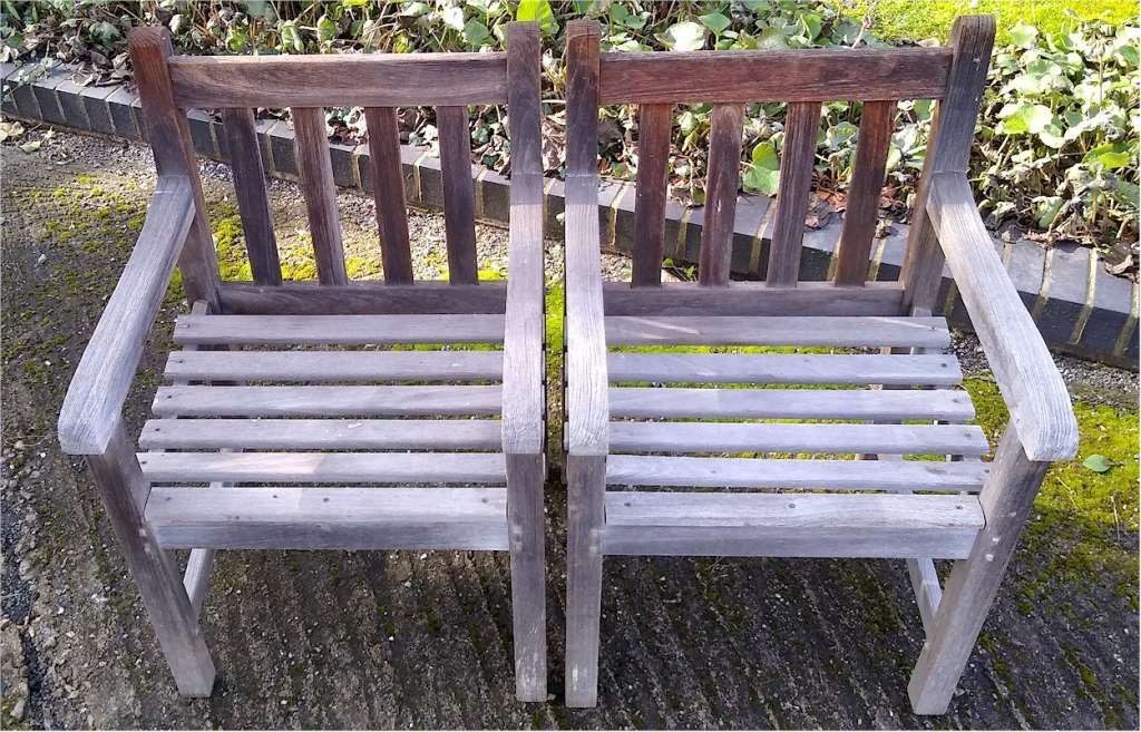 Pair of heavy , teak garden chairs , doweled joints