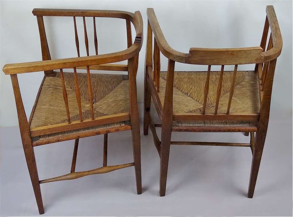 Pair of arts and crafts tub chairs in oak