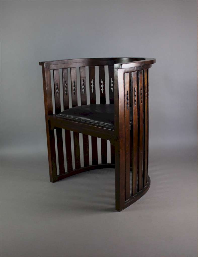 Arts and Crafts mahogany barrel chair with pierced cutouts. c1910