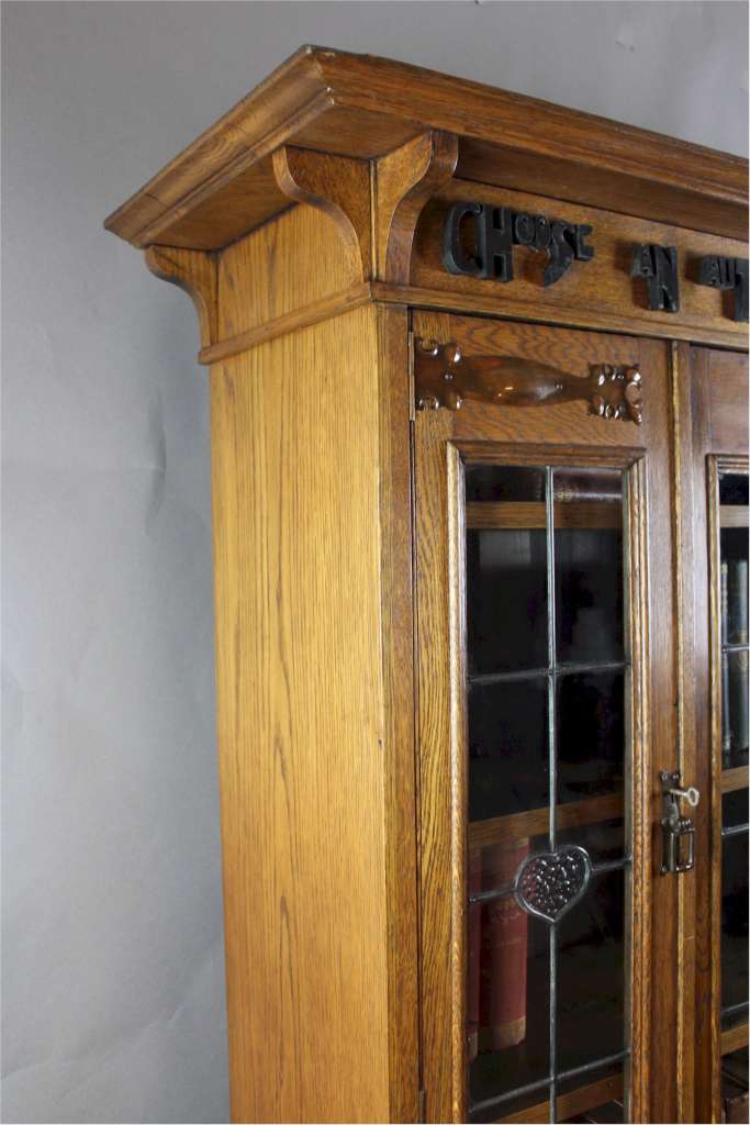 Arts and Crafts oak glazed bookcase with Motto