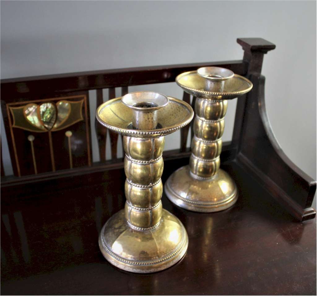 Pair of brass arts and crafts candlesticks