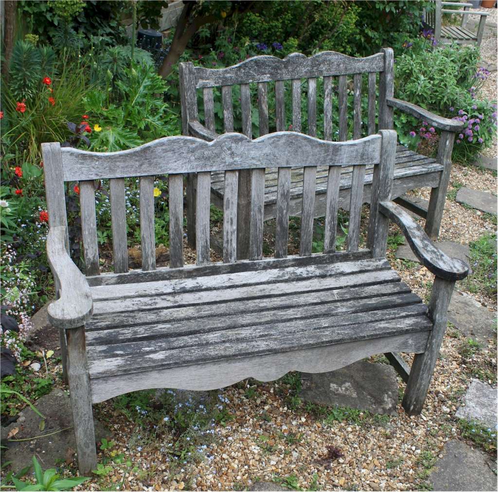 Pair of Teak garden benches with oak leaf decoration