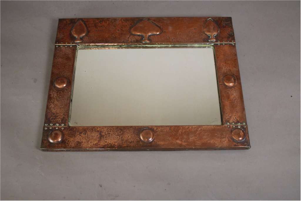 Arts and crafts copper mirror with raised spear motifs