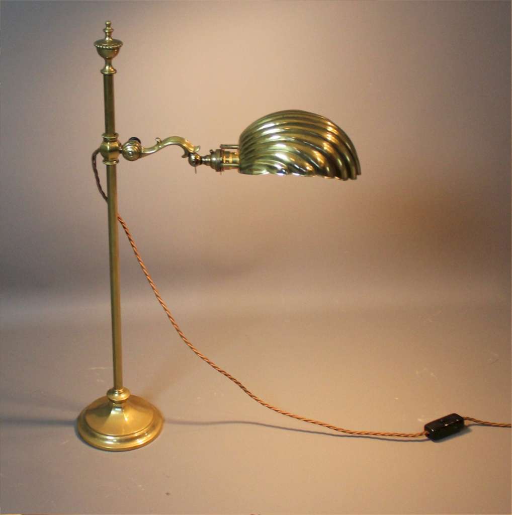 Arts and crafts desk lamp by Faraday and Sons. Brass adjustable desk lamp with brass shell shade . F