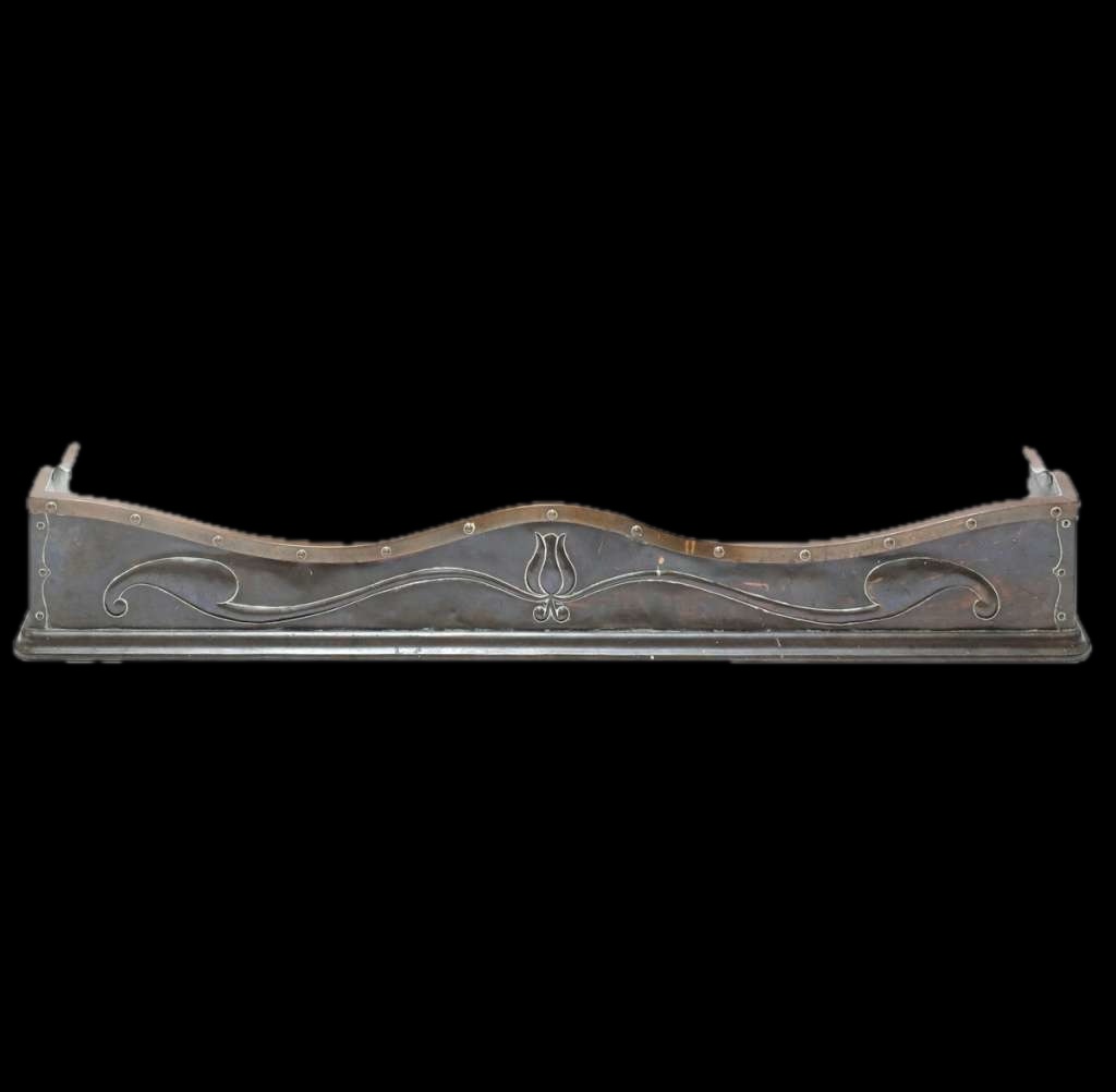 An Arts and Crafts bronze and copper fender