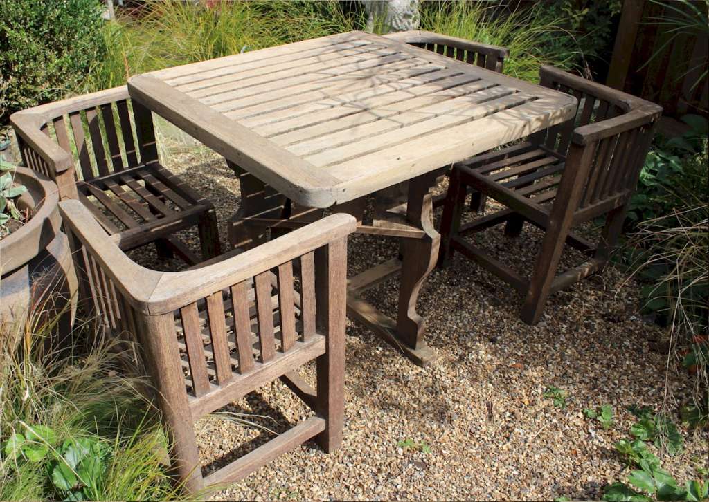  Heals teak garden table and four chairs. c1930
