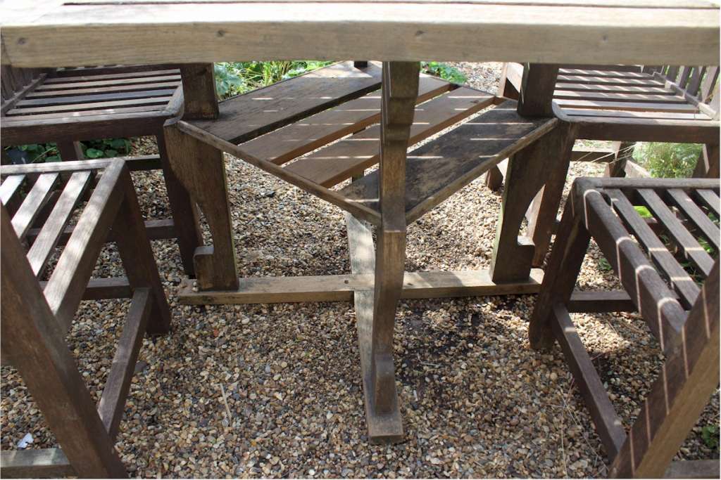  Heals teak garden table and four chairs. c1930
