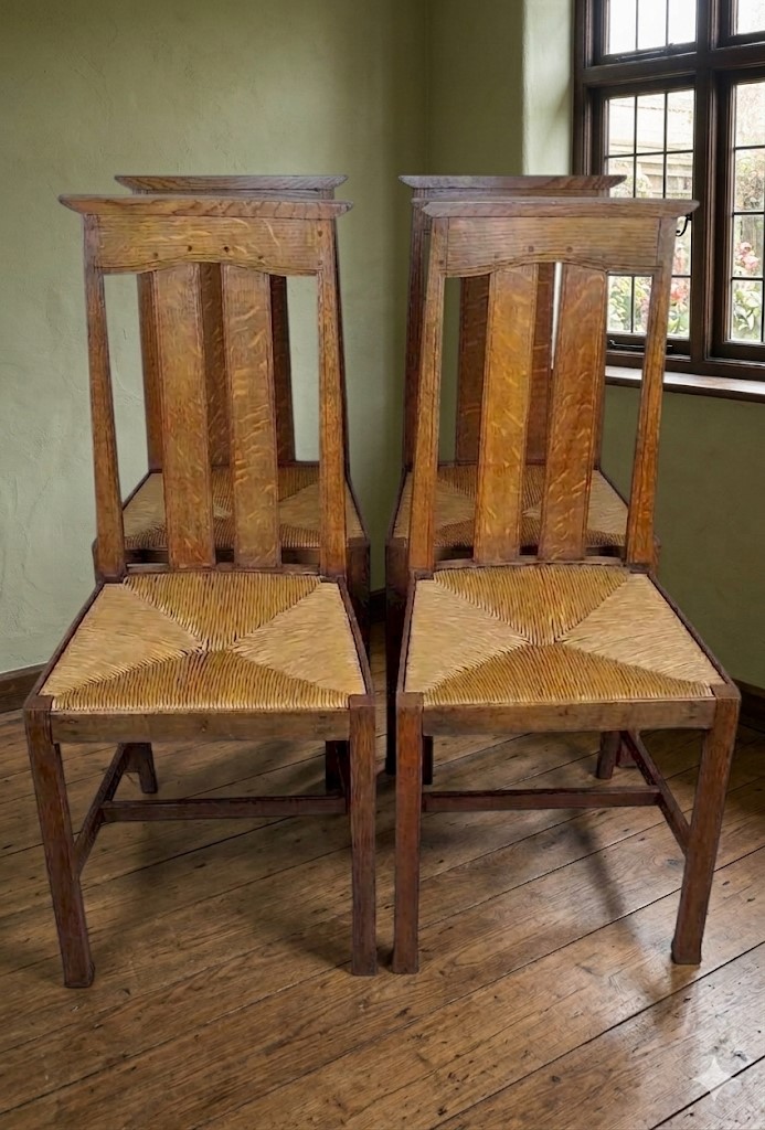 Arts and crafts oak dining chairs by Liberty
