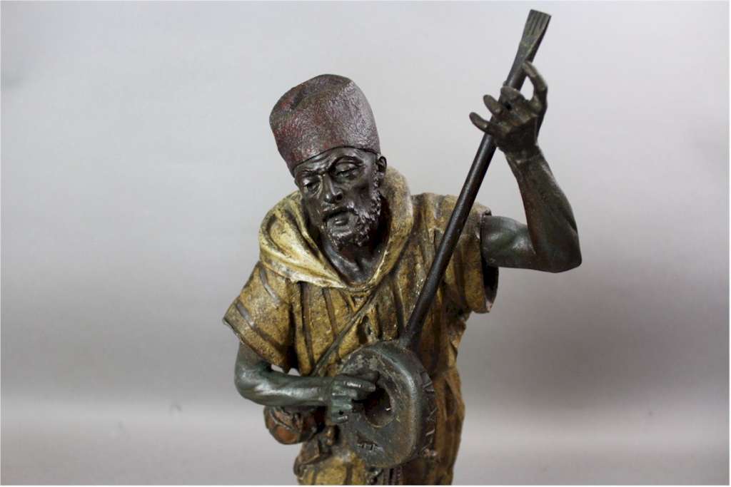 Large spelter figure of an Arab Bedouin playing the mandolin