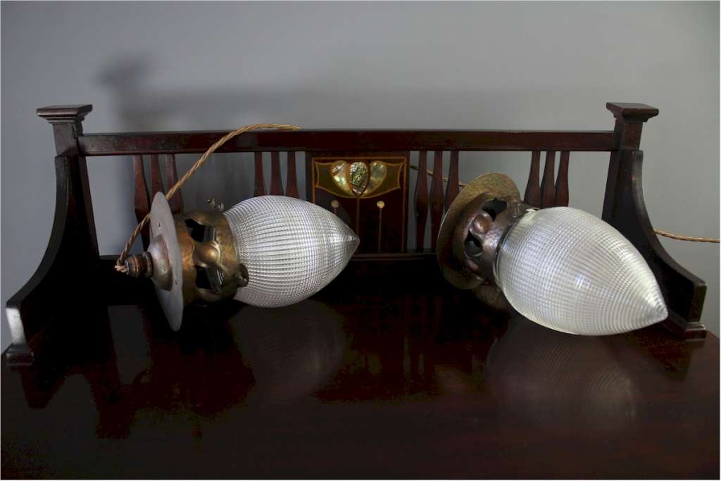 Pair of arts and crafts copper pendant lights with Holophane glass shades