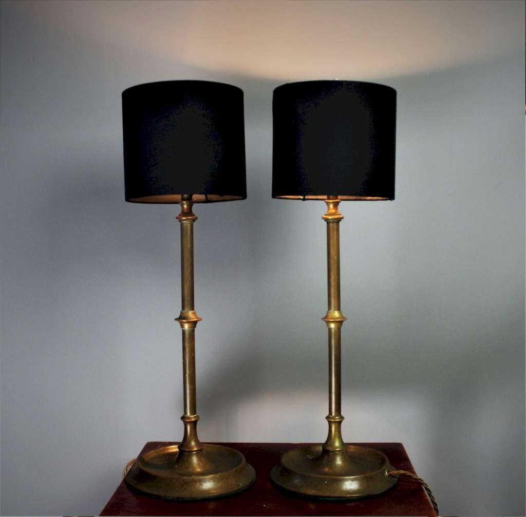 Pair of brass table lamps on circular bases