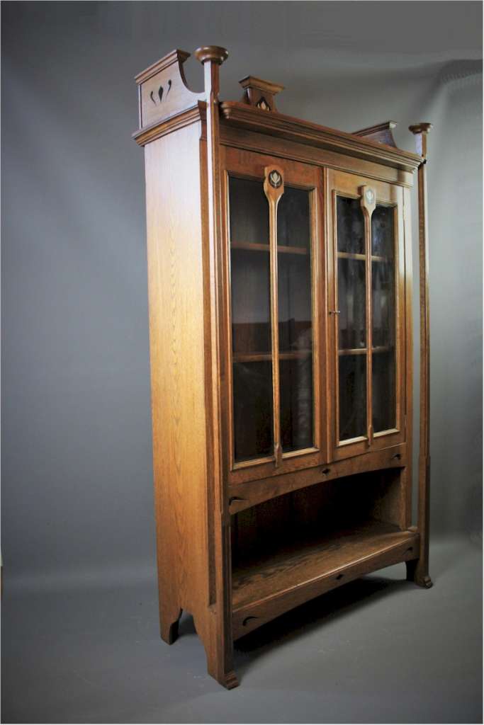 Arts and Crafts oak bookcase with ebony and pewter inlay.