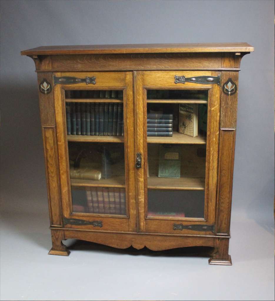 Pewter and ebony inlaid arts and crafts bookcase