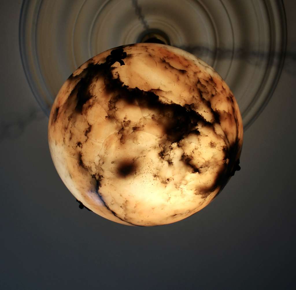 Alabaster ceiling shade with pinkish grain.