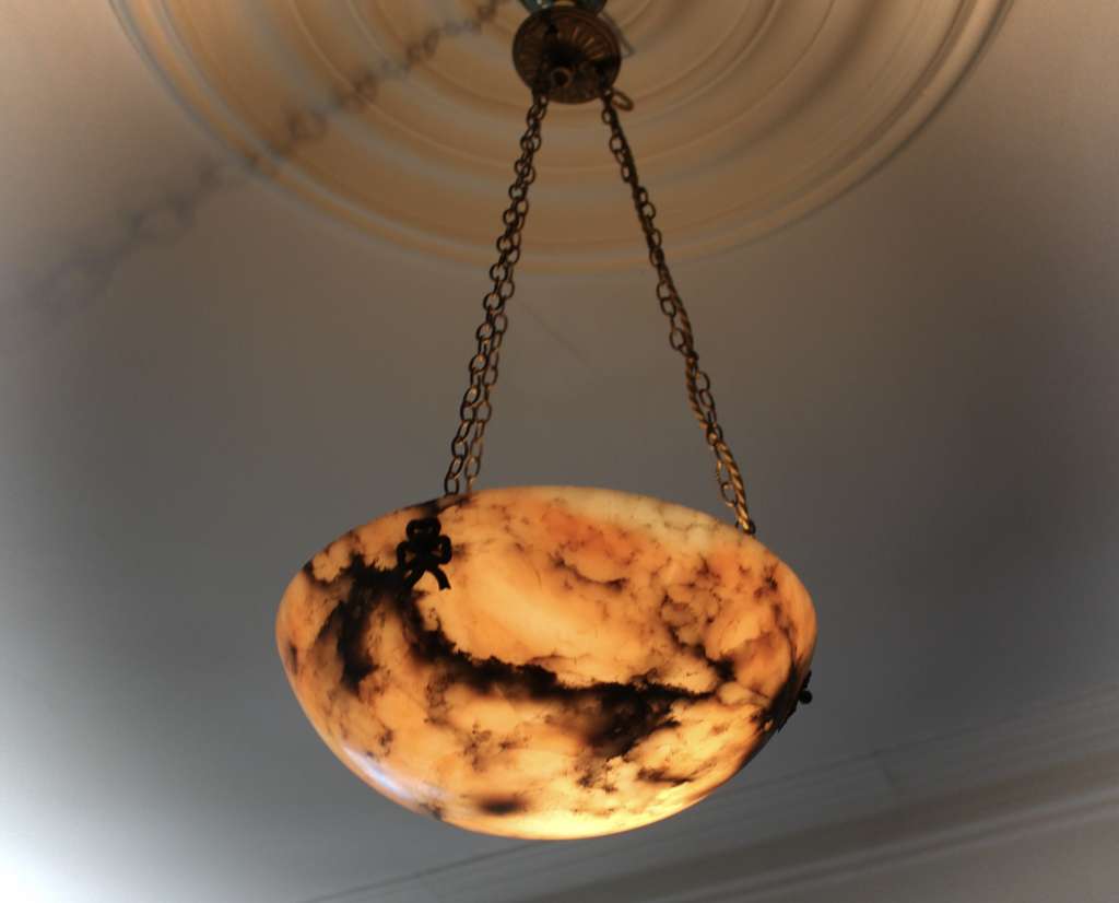 Alabaster ceiling shade with pinkish grain.