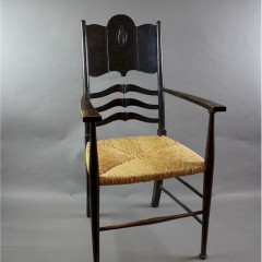 Arts and Crafts elbow chair with rush seat.