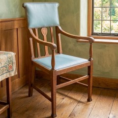 Arts and crafts armchair with carved heart decoration